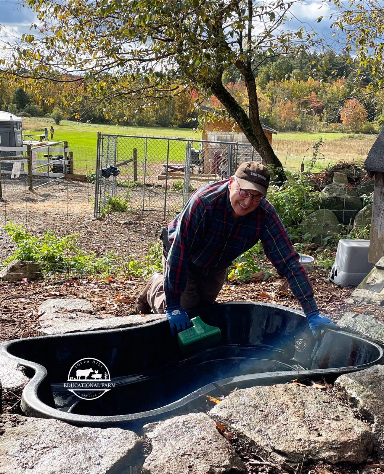 One of our amazing volunteers scrubbing the duck pond.